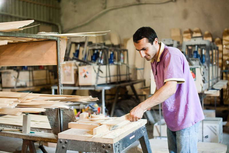 A man working with wood in a carpentry workshop.